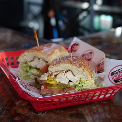 The Woodside Wildcats sandwich with chicken, bacon, avocado, lettuce, and tomatoes.