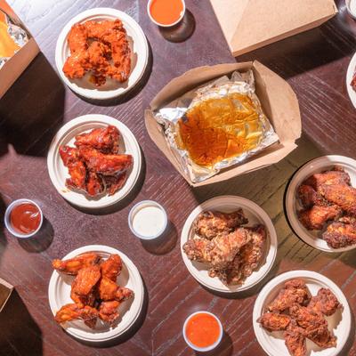 Various chicken wings and dipping sauces.