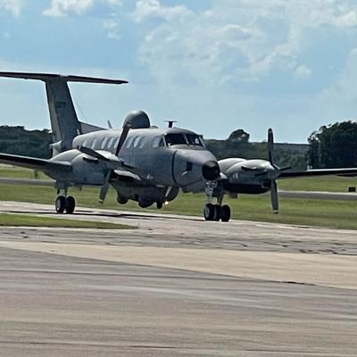 A military airplane on a taxi runway.