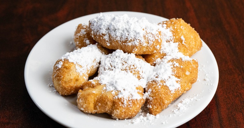 Fried dough pastries topped with powdered sugar