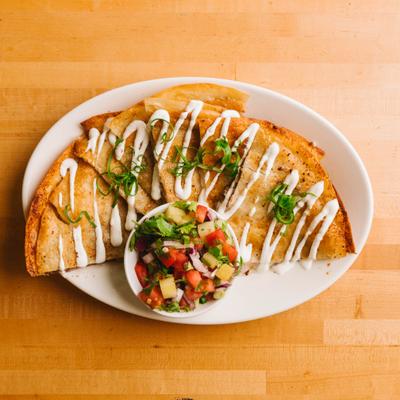 Kalua pork quesadilla served with fresh salsa.