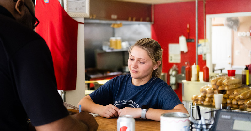 The staff serves the customer