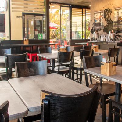 Diner table, chairs, close up, diner area behind.