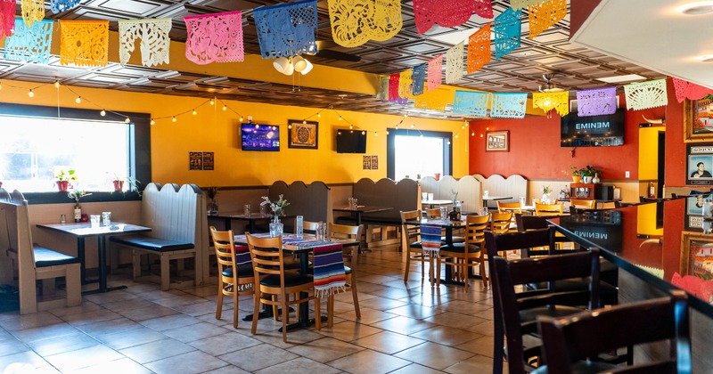 Interior seating area with chairs, tables and double booths