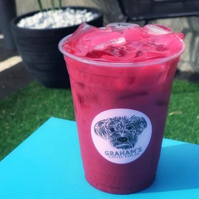 Iced pink drink in plastic cup with a Graham's Coffee Parlor logo.