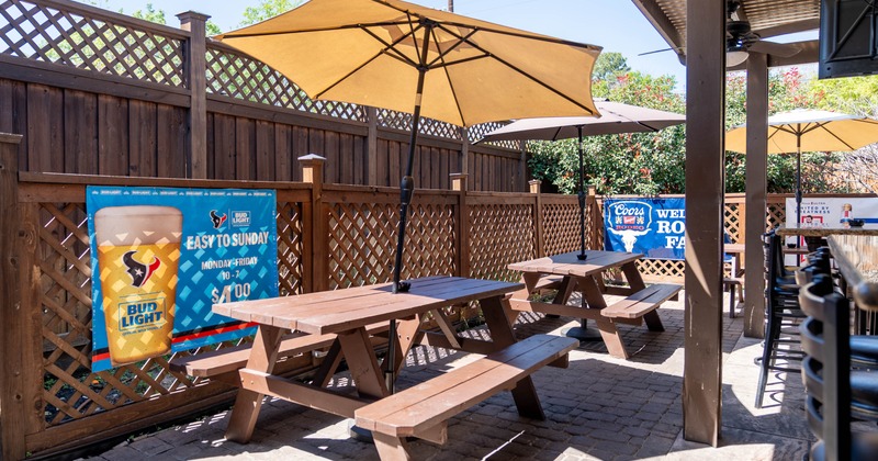 Exterior, partially covered seating, tables with benches under parasols