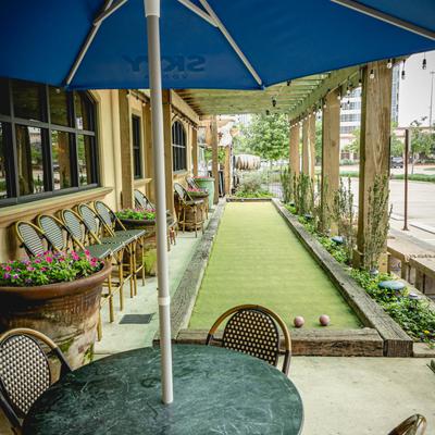Exterior, bocce ball play terrain, table in front.