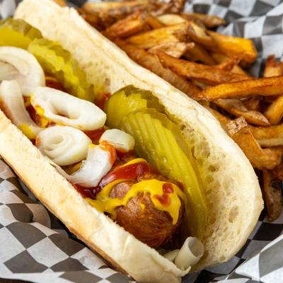 Fenway hot dog with ketchup, mustard, pickles, and onions, served with fries.