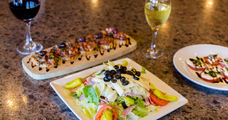 Antipasto Italiano salad, caprese, and bruschetta served together with red and white wine