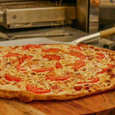Margherita pizza served on a wooden tray.