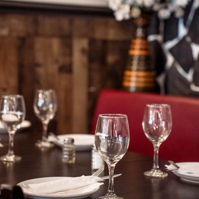 Table with plates, napkins, utensils, and glasses.