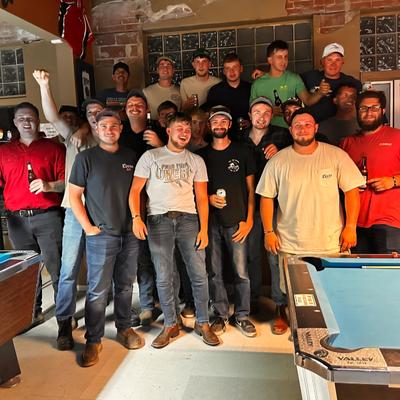 customers posing for a group photo.