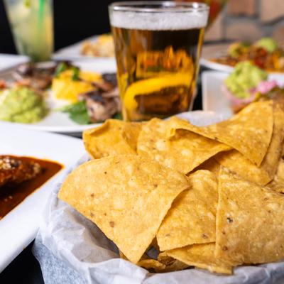 Nachos, a beer, and other food.