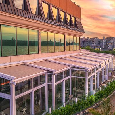 Waterfront event venue glowing at sunset.