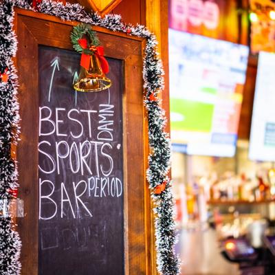 Chalkboard sign inside a bar that claims to be the best sports bar.