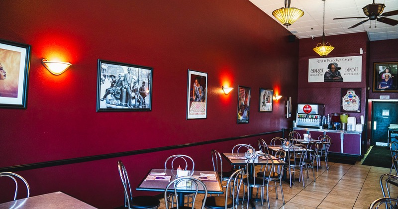 Interior, tables and chairs, framed pictures on the wall