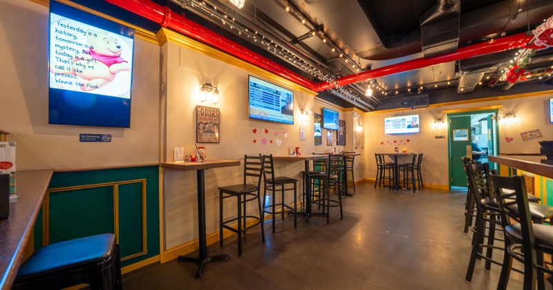 Interior of a sports bar with high tables and stools