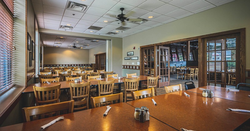 Interior, lined up dining tables waiting for guests