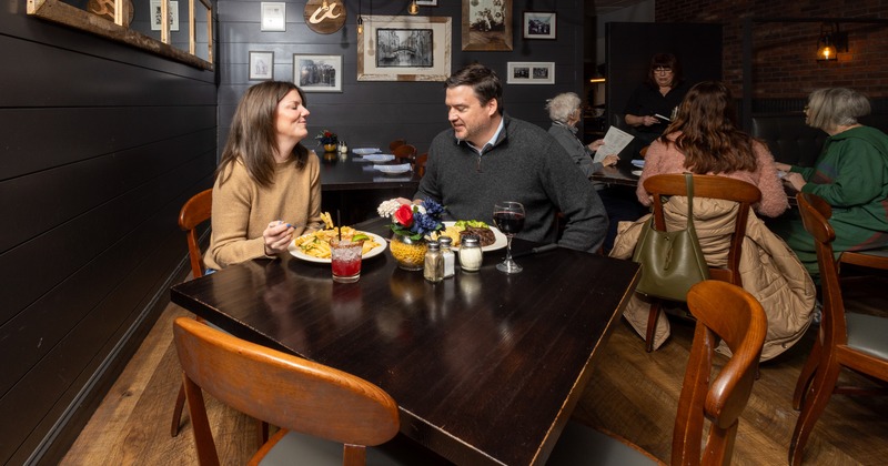 Diner table for 2,  Couple sitting and  has lunch