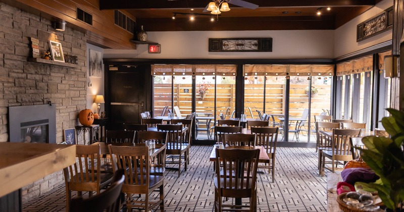 Interior with wooden tables, stone wall, and seasonal decorations