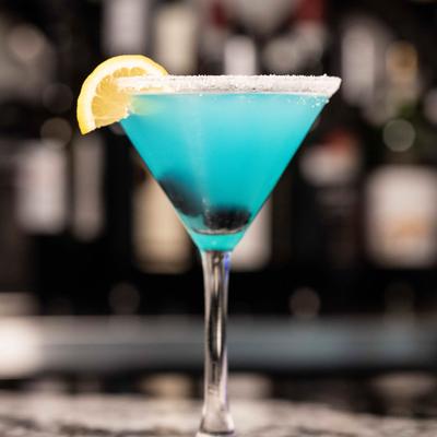 Blackberry Lemon Drop martini sits on a bar counter.