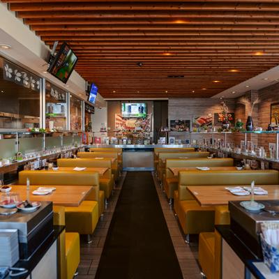 Dining room with yellow booths and wood ceiling.