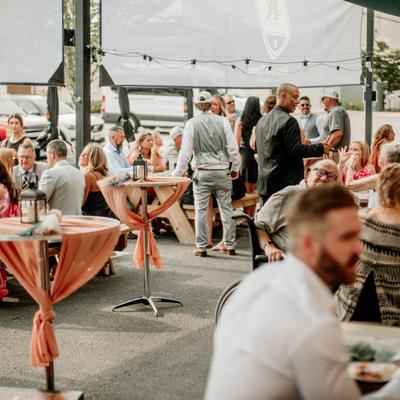 Wedding party happening on an outdoor patio.