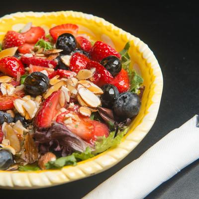 Summer salad, with mixed berries and nuts.