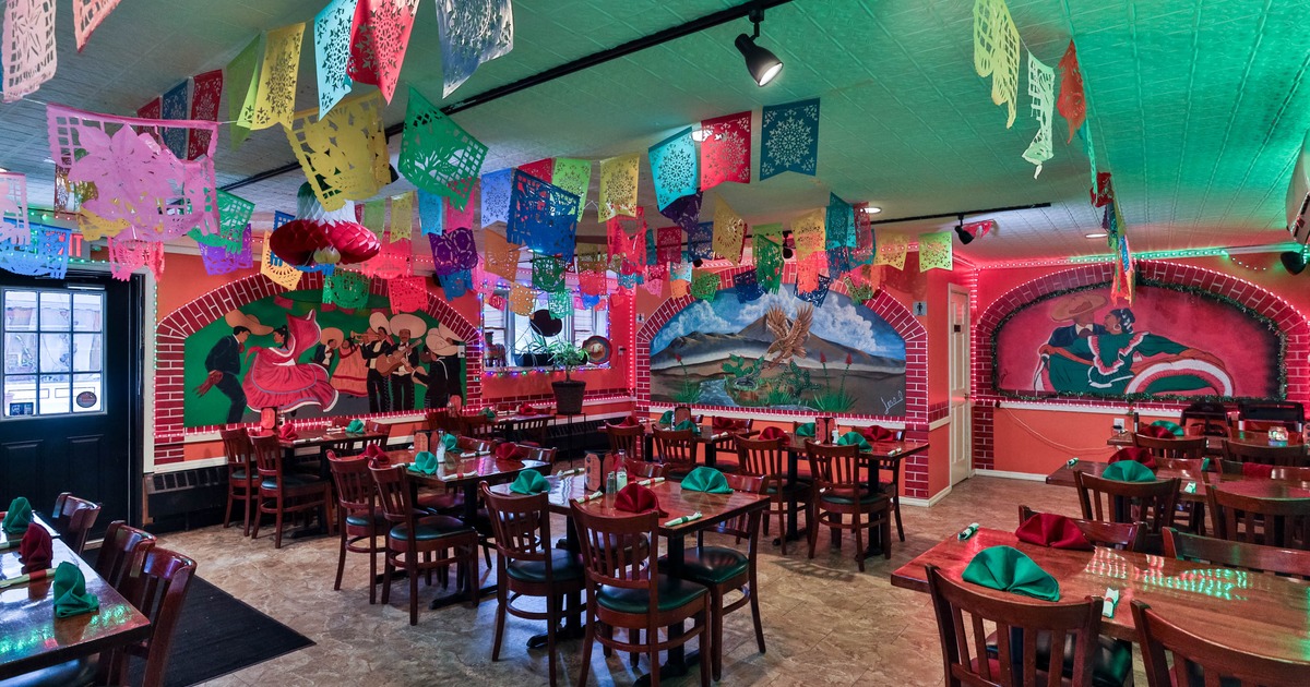 Interior, open space dining area, tables with chairs, Mexican motif inspired decoration