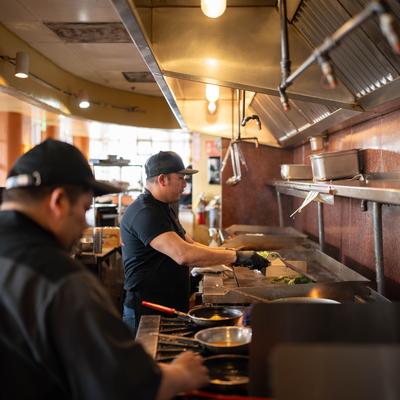 Two chefs working in a commercial kitchen.