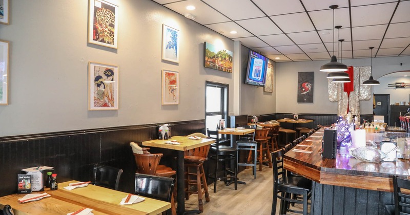 Interior, high tables and chairs, bar and bar stools on the right