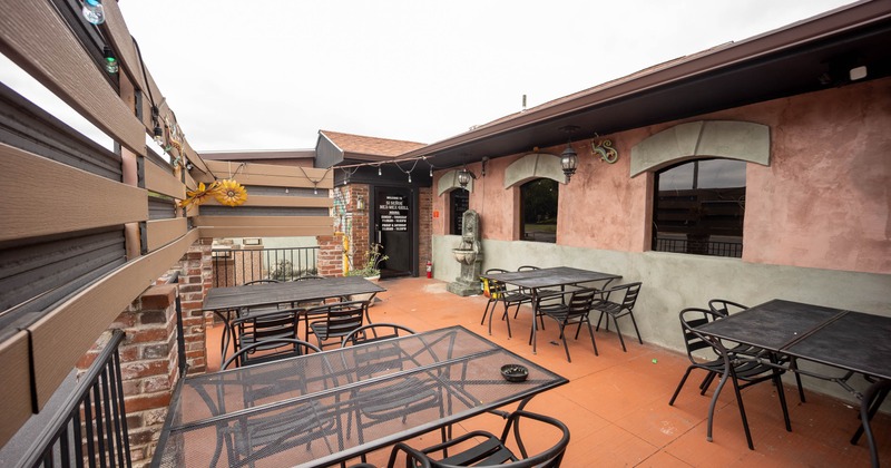 Outdoor restaurant patio with metal tables and chairs