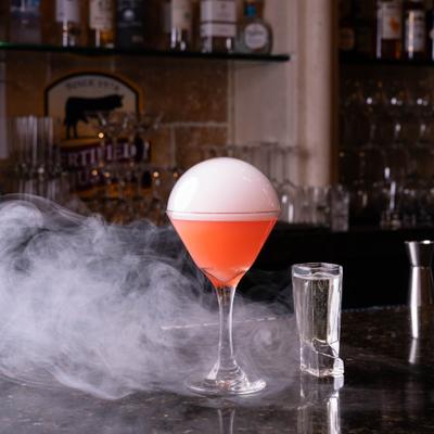 Cocktail in Nick and Nora glass garnished with smoke bubble.