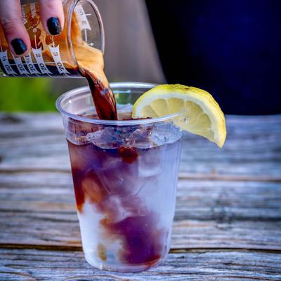 pouring espresso into espresso tonic.