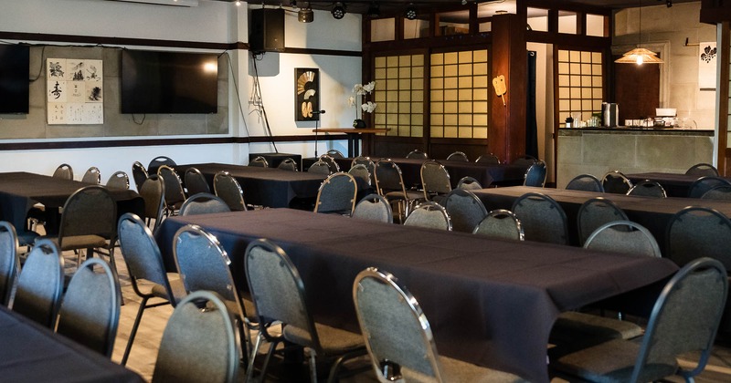 Interior, tables and chairs with TV on the wall