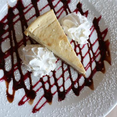 Cheesecake and whipped cream, top view.