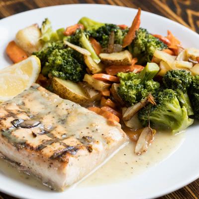Grilled salmon, with lemon and white wine sauce, and veggies.