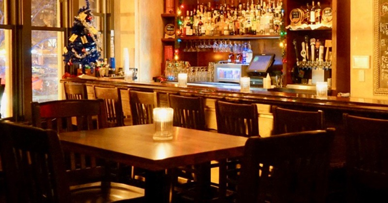 Exterior, tables and chairs ready for guests, bar on the right