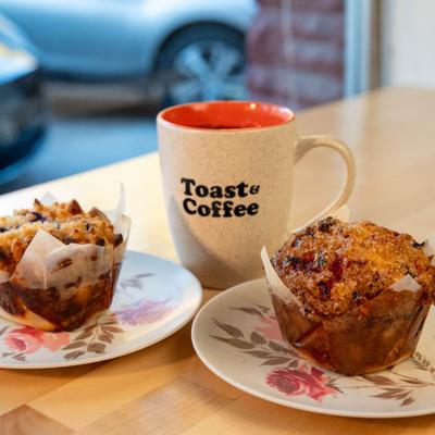 Two muffins and coffee in a branded mug.