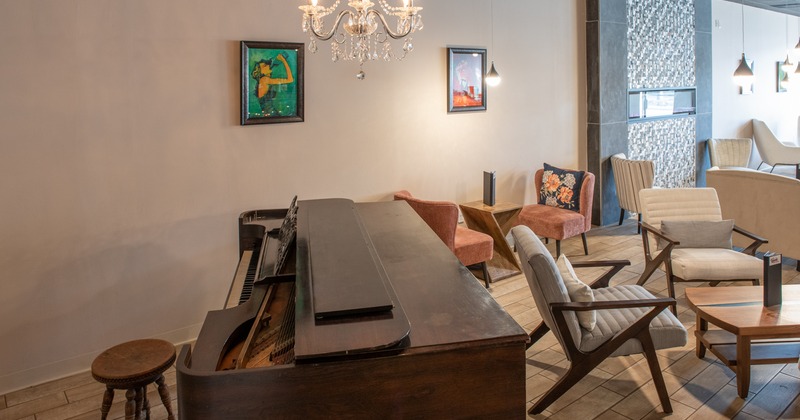 Piano, armchairs and chandelier romantic atmosphere