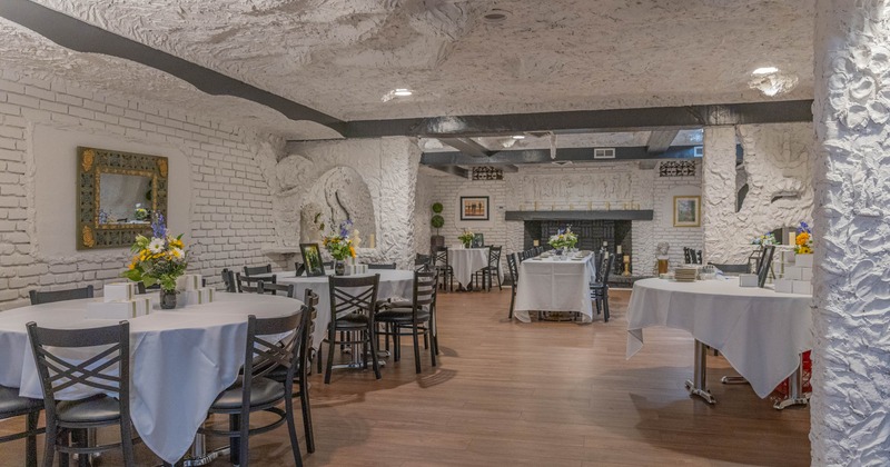 Interior, dining room, wooden floors, and tables set with flower arrangements
