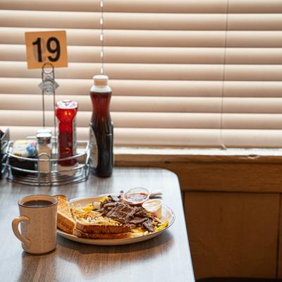 Steak fajita omelet served with coffee.