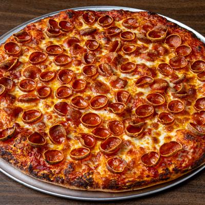 Whole Pepperoni pizza served on a metal tray.