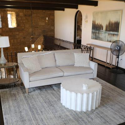 A white sofa and a table.