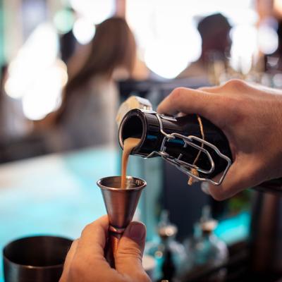 Hands pouring a drink.