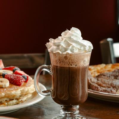 A steaming hot chocolate topped with sweet whip cream..