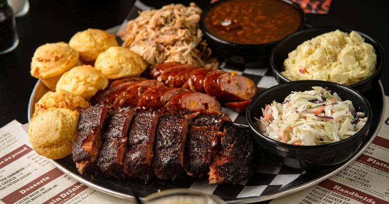 Bubbie's Family Feast platter with meats and sides on it