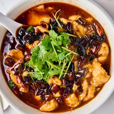 Bowl of braised fish in red chili oil.