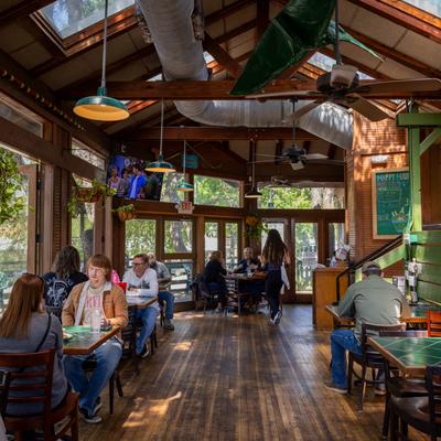 People dining inside the rustic wood paneled restaurant.
