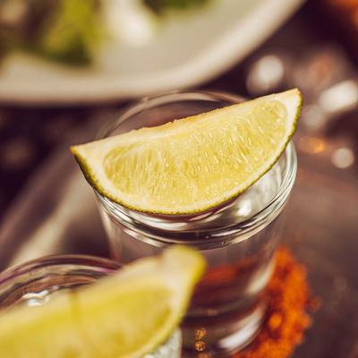 Tequila flight, close-up of a tequila shot with lime garnish